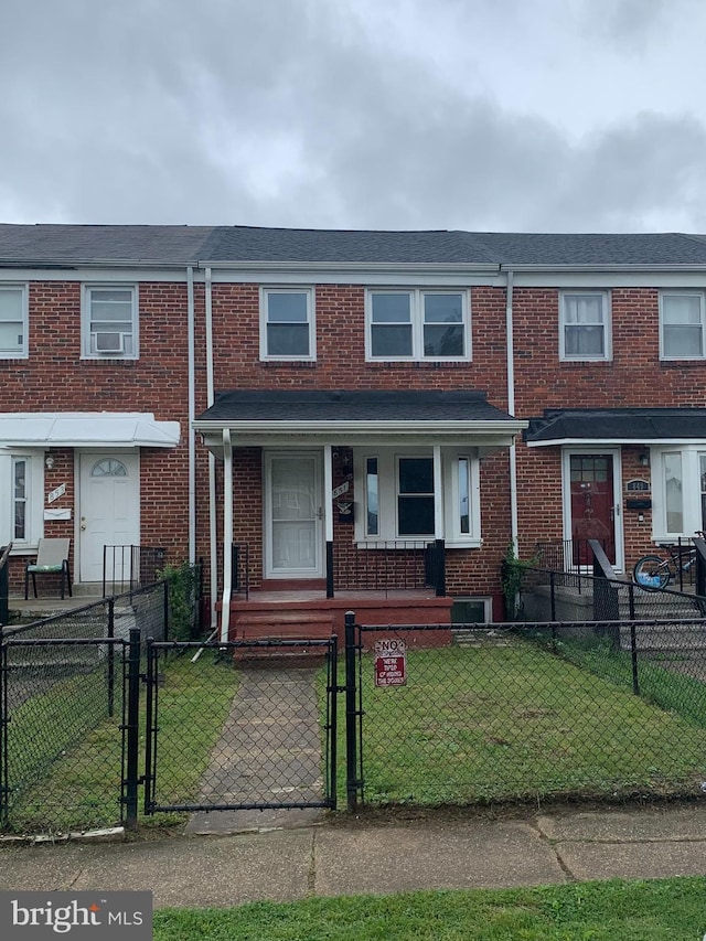 851 Arncliffe Rd, Baltimore, MD 21221 - townhome / multi-family property featuring brick siding, a porch, and a gate