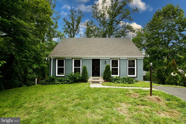 13732 Moccasin Ct, Woodbridge, VA 22193 - new england style home featuring brick siding, a front yard, a chimney, and roof with shingles