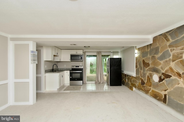 13732 Moccasin Ct, Woodbridge, VA 22193 - kitchen with appliances with stainless steel finishes, a sink, white cabinets, open floor plan, and light colored carpet