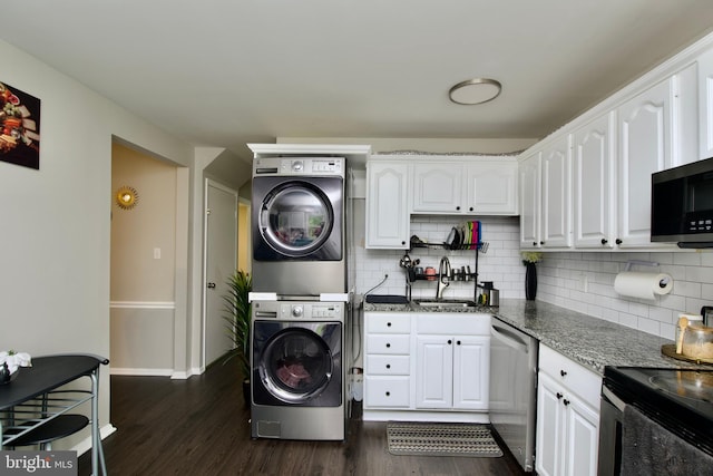 13732 Moccasin Ct, Woodbridge, VA 22193 - kitchen featuring appliances with stainless steel finishes, stacked washer / dryer, a sink, dark wood finished floors, and white cabinets