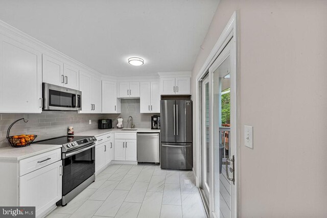 20429 Ambassador Ter Unit 20429, Germantown, MD 20874 - kitchen with stainless steel appliances, white cabinetry, light countertops, and a sink