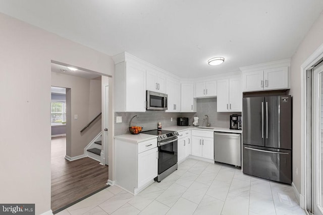 20429 Ambassador Ter Unit 20429, Germantown, MD 20874 - kitchen featuring appliances with stainless steel finishes, a sink, light countertops, and white cabinets