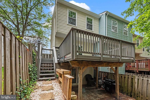 20429 Ambassador Ter Unit 20429, Germantown, MD 20874 - rear view of property featuring a wooden deck, a fenced backyard, and stairs