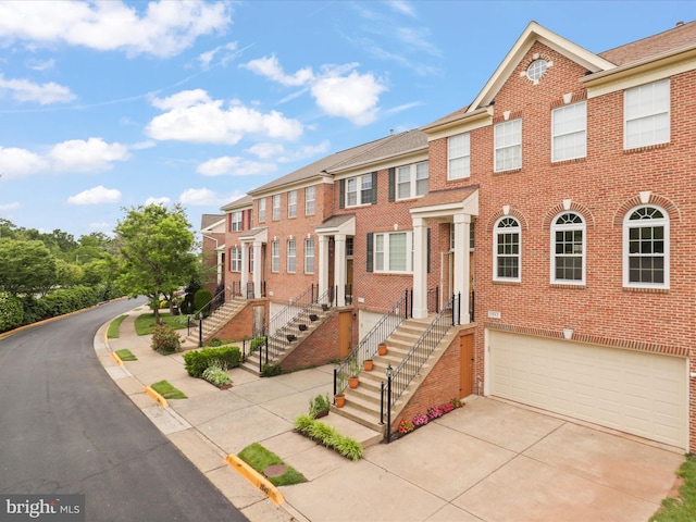 2642 Logan Wood Dr, Herndon, VA 20171 - townhome / multi-family property featuring brick siding, driveway, and an attached garage
