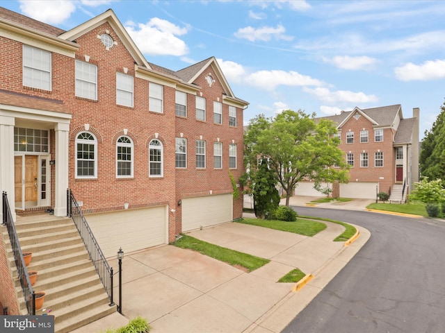 2642 Logan Wood Dr, Herndon, VA 20171 - view of front of house featuring brick siding, an attached garage, and concrete driveway