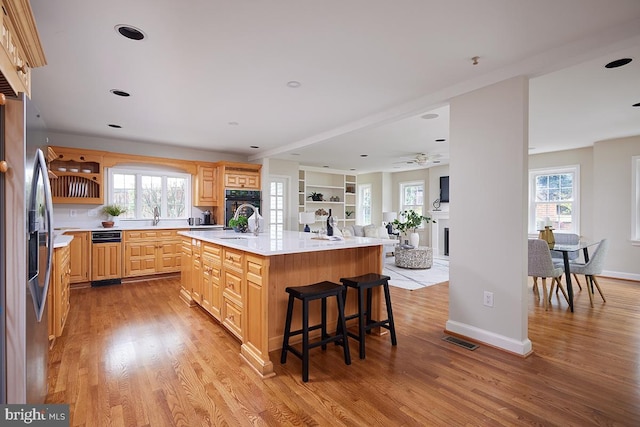 5403 Center St, Chevy Chase, MD 20815 - kitchen with oven, light brown cabinetry, light wood-type flooring, and light countertops