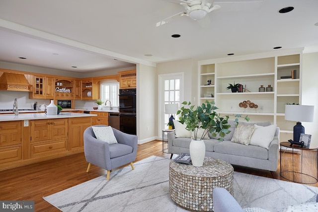 5403 Center St, Chevy Chase, MD 20815 - living area with light wood-style floors, ceiling fan, and baseboards