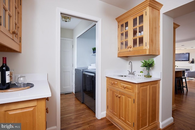 5403 Center St, Chevy Chase, MD 20815 - kitchen featuring a sink, separate washer and dryer, dark wood-style floors, and light countertops