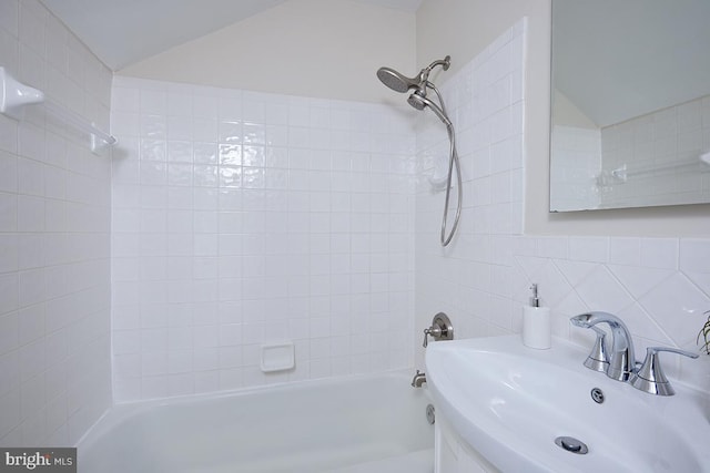 5403 Center St, Chevy Chase, MD 20815 - bathroom with shower / bath combination, vanity, backsplash, tile walls, and vaulted ceiling