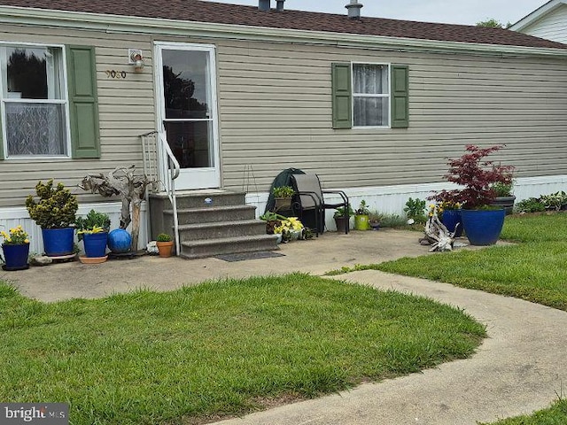 9080 Gold Finch Ct, Hebron, MD 21830 - entrance to property with a lawn, roof with shingles, and a patio area