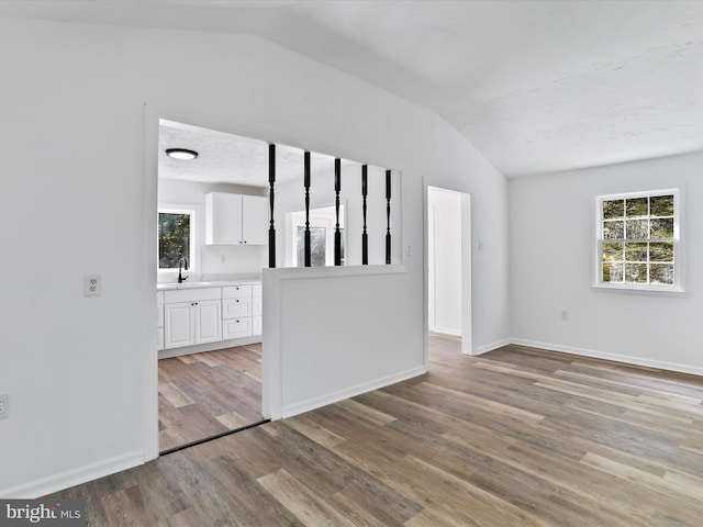 153 Bear Track Rd, Augusta, WV 26704 - unfurnished room featuring vaulted ceiling, light wood finished floors, baseboards, and a sink