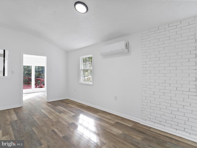 153 Bear Track Rd, Augusta, WV 26704 - spare room featuring vaulted ceiling, a wall unit AC, dark wood-type flooring, and baseboards