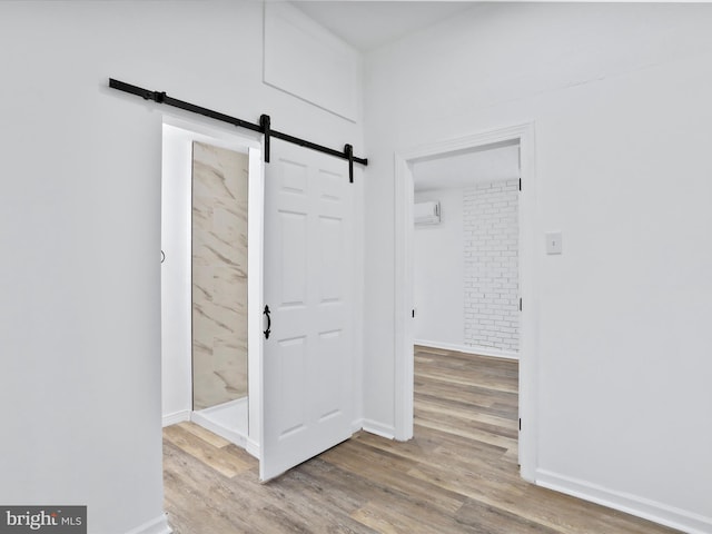 153 Bear Track Rd, Augusta, WV 26704 - foyer entrance with a barn door, wood finished floors, a wall mounted air conditioner, and baseboards