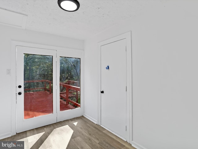 153 Bear Track Rd, Augusta, WV 26704 - doorway featuring wood finished floors and a textured ceiling