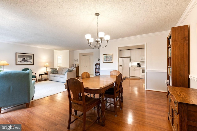 4100 N Charles St Unit 203, Baltimore, MD 21218 - dining room with a textured ceiling, a chandelier, crown molding, and wood finished floors