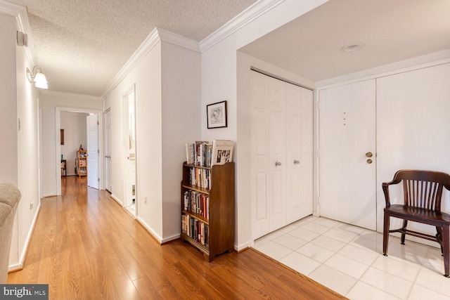 4100 N Charles St Unit 203, Baltimore, MD 21218 - foyer entrance with light wood finished floors, crown molding, a textured ceiling, and baseboards