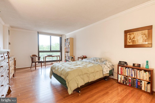 4100 N Charles St Unit 203, Baltimore, MD 21218 - bedroom featuring crown molding, light wood-type flooring, and a textured ceiling