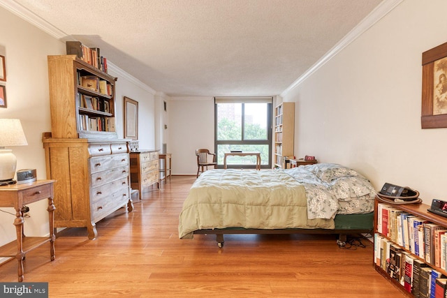 4100 N Charles St Unit 203, Baltimore, MD 21218 - bedroom featuring a textured ceiling, ornamental molding, and light wood finished floors
