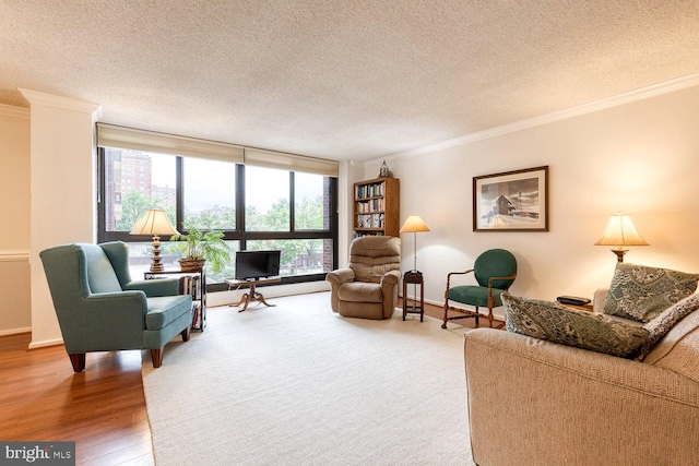 4100 N Charles St Unit 203, Baltimore, MD 21218 - living area featuring ornamental molding, a textured ceiling, wood finished floors, and baseboards