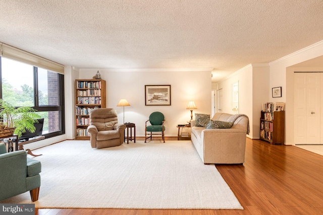 4100 N Charles St Unit 203, Baltimore, MD 21218 - living area with crown molding, wood finished floors, a textured ceiling, and baseboards