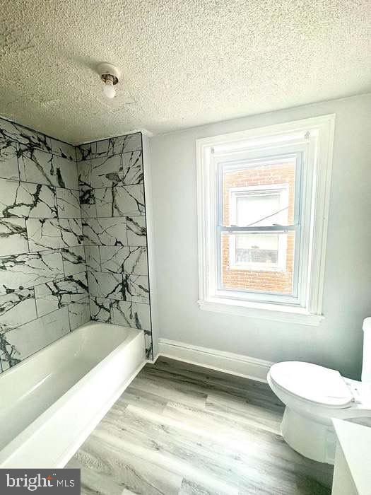 1035 N Pine St, Wilmington, DE 19801 - full bath with toilet, a textured ceiling, shower / washtub combination, wood finished floors, and vanity