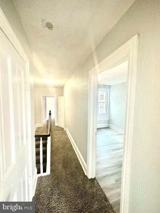 1035 N Pine St, Wilmington, DE 19801 - hall with a textured ceiling and baseboards