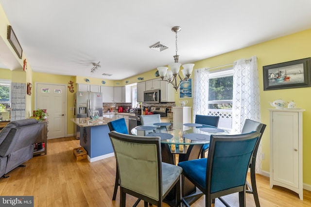 25 N 12th St, Del Haven, NJ 08251 - dining area with a chandelier, healthy amount of natural light, and light wood-style floors