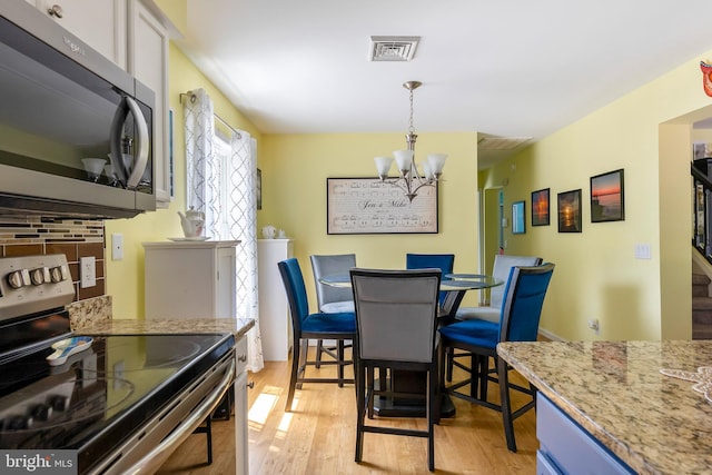 25 N 12th St, Del Haven, NJ 08251 - dining space featuring a chandelier and light wood-style floors