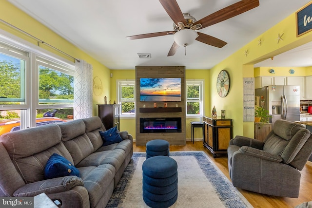 25 N 12th St, Del Haven, NJ 08251 - living area with wood finished floors, a ceiling fan, and a fireplace