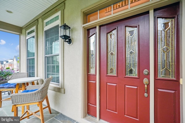 47666 Paulsen Sq, Potomac Falls, VA 20165 - property entrance featuring a porch and stucco siding