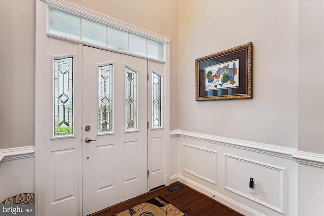 47666 Paulsen Sq, Potomac Falls, VA 20165 - foyer with dark wood finished floors, wainscoting, plenty of natural light, and a decorative wall