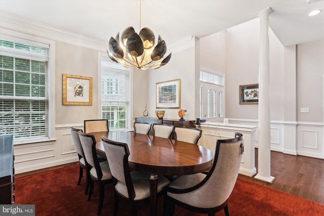 47666 Paulsen Sq, Potomac Falls, VA 20165 - dining area with decorative columns, dark wood-style flooring, a chandelier, wainscoting, and ornamental molding