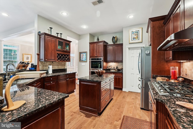 47666 Paulsen Sq, Potomac Falls, VA 20165 - kitchen featuring appliances with stainless steel finishes, tasteful backsplash, light wood-style flooring, a sink, and recessed lighting