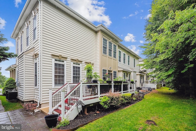 47666 Paulsen Sq, Potomac Falls, VA 20165 - back of house with a yard, central AC unit, and a deck