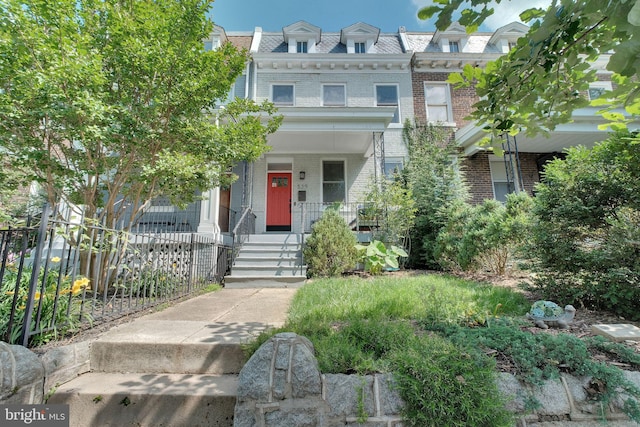 539 Shepherd St NW, Washington, DC 20011 - view of front of home featuring brick siding, a porch, and mansard roof