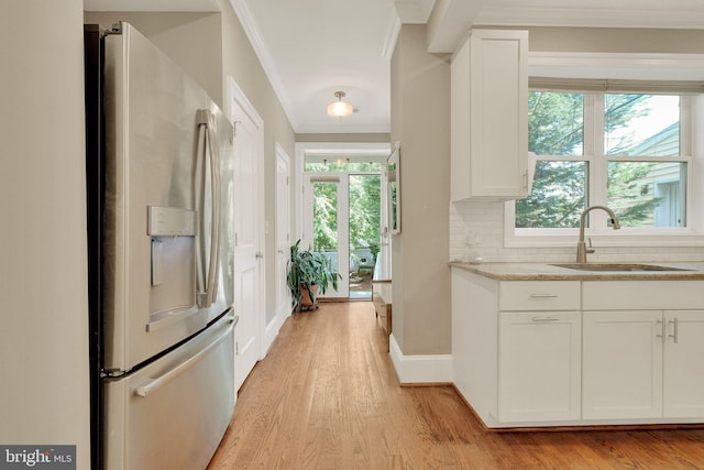 539 Shepherd St NW, Washington, DC 20011 - kitchen featuring stainless steel refrigerator with ice dispenser, a sink, crown molding, light wood-style floors, and white cabinetry
