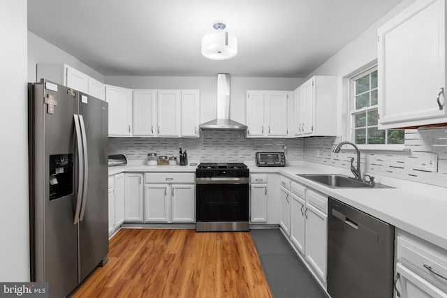6 E Saxony Dr, New Castle, DE 19720 - kitchen with appliances with stainless steel finishes, wall chimney range hood, a sink, and backsplash