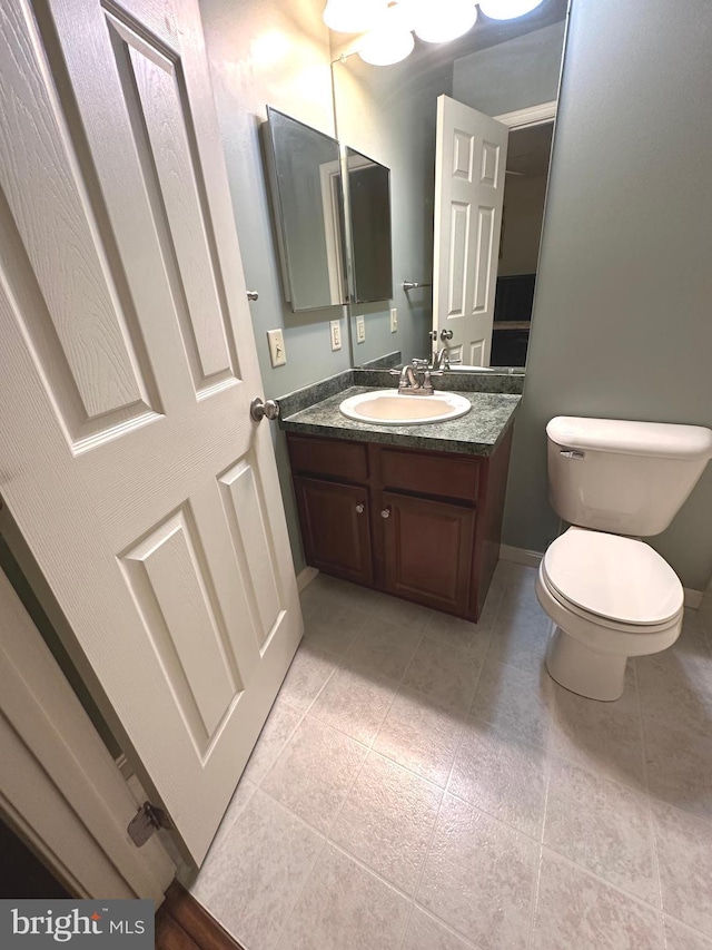 413 Park View Dr, Harrisburg, PA 17110 - half bathroom featuring toilet, vanity, baseboards, and tile patterned floors