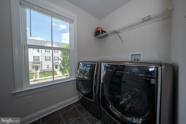500 Quarry Point Rd, Malvern, PA 19355 - washroom featuring washing machine and clothes dryer, baseboards, healthy amount of natural light, and dark tile patterned flooring
