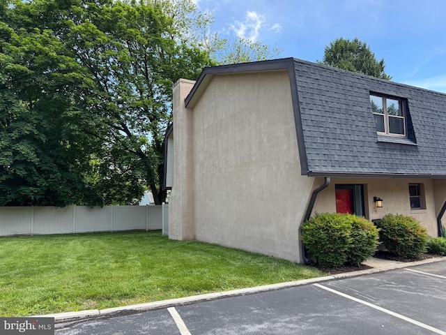 315 S Valley Forge Rd Unit 7, Devon, PA 19333 - view of home's exterior featuring uncovered parking, a shingled roof, stucco siding, and a chimney