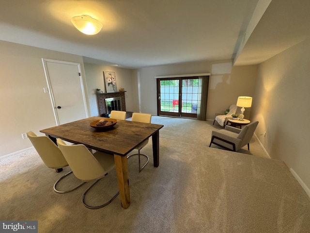 315 S Valley Forge Rd Unit 7, Devon, PA 19333 - dining room with a brick fireplace, light carpet, and baseboards