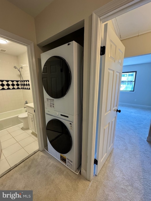 315 S Valley Forge Rd Unit 7, Devon, PA 19333 - laundry room with stacked washer / dryer, light carpet, and baseboards