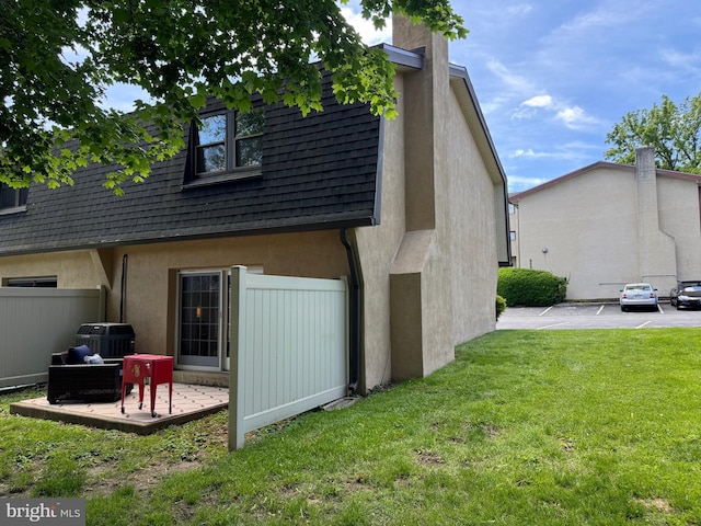 315 S Valley Forge Rd Unit 7, Devon, PA 19333 - rear view of house featuring stucco siding, a chimney, and central AC unit