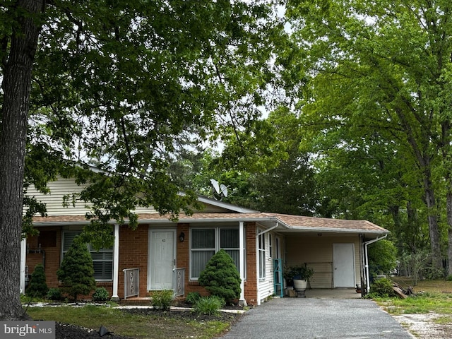 43 Magnolia Rd, Manahawkin, NJ 08050 - view of front of property with asphalt driveway, an attached carport, and brick siding