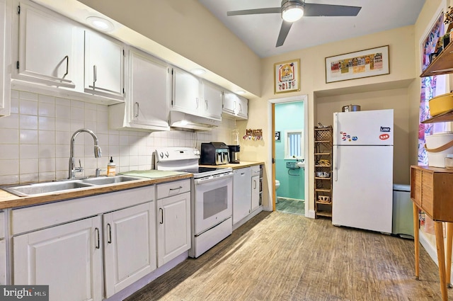 134 N Plum St, Lancaster, PA 17602 - kitchen with white appliances, a sink, under cabinet range hood, backsplash, and light wood-style flooring