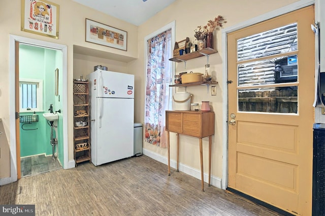 134 N Plum St, Lancaster, PA 17602 - kitchen with freestanding refrigerator, wood finished floors, and baseboards