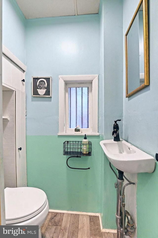 134 N Plum St, Lancaster, PA 17602 - bathroom with toilet, wood finished floors, and baseboards
