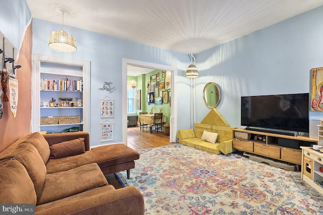 134 N Plum St, Lancaster, PA 17602 - living room featuring radiator heating unit and wood finished floors