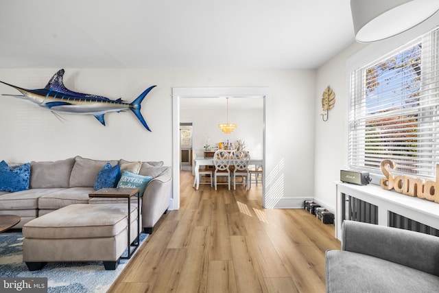 27 E Groveland Ave, Somers Point, NJ 08244 - living room featuring light wood-style flooring, healthy amount of natural light, baseboards, and a chandelier