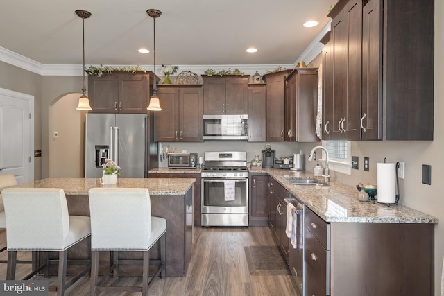 500 Prince George Dr, Lancaster, PA 17601 - kitchen with stainless steel appliances, a sink, dark brown cabinets, ornamental molding, and dark wood-style floors